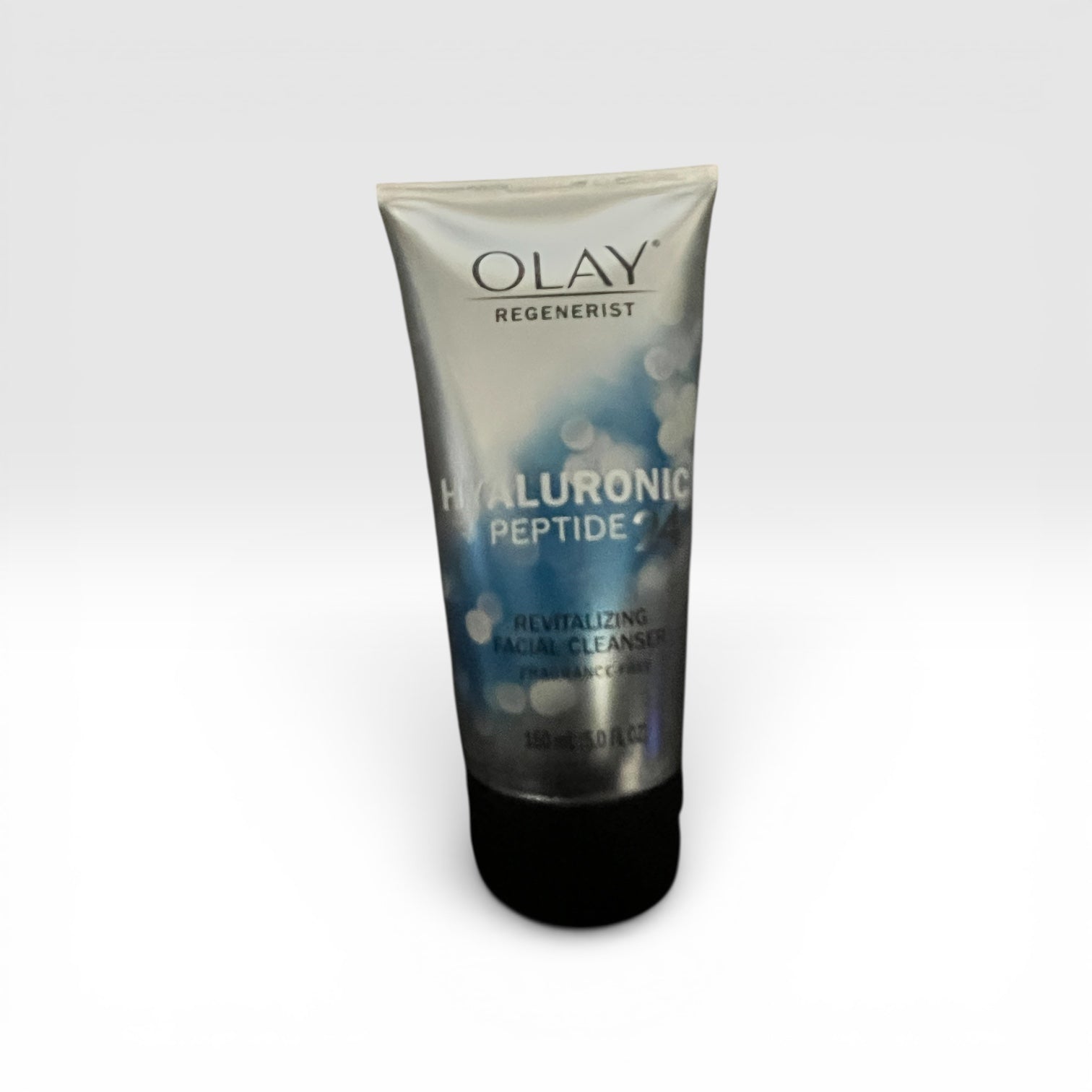 Olay Regenerist Hyaluronic Peptide facial cleanser tube on a white background